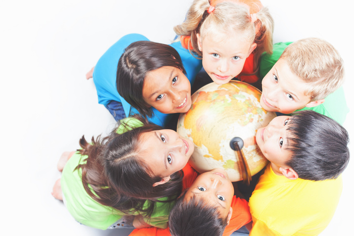 Group of international kids holding globe earth
